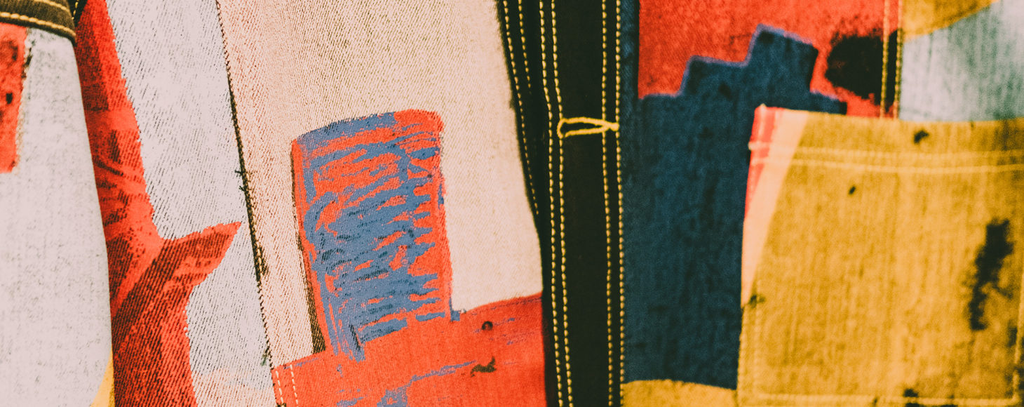 A jacket designed by Bethany Williams shown in a close up detail. The jacket is made using printed denim fabrics.