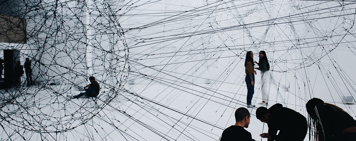 Gallery space with art installation made of black cables