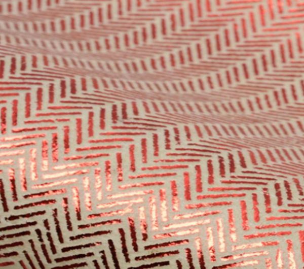 Sample of an un-woven fabric with red print repeat on top